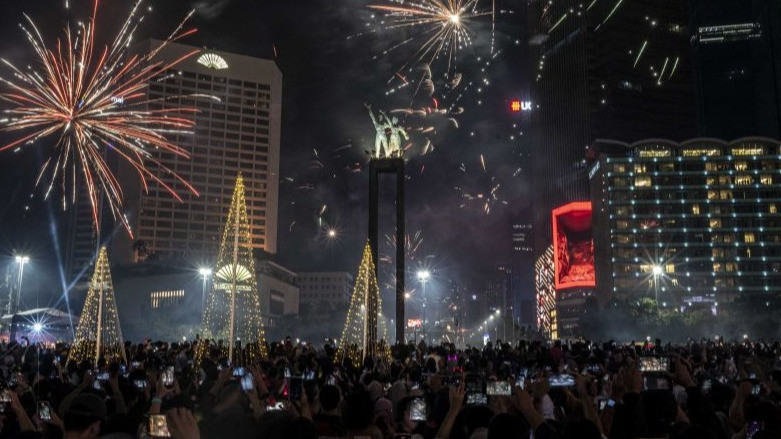 Ribuan warga menyaksikan pesta kembang api menyambut Tahun Baru 2023 di kawasan Bundaran HI, Jakarta, Senin (1/1/2023).